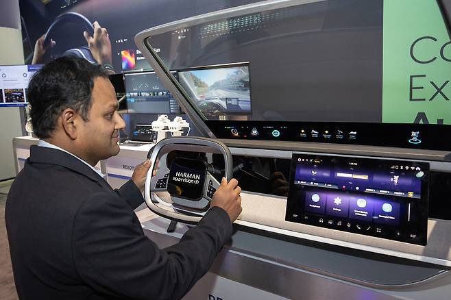 A visitor experiences Harman's Ready Vision Qvue and Luna, augmented reality-based heads-up displays, at Harman's booth at CES 2025. (Samsung Electronics)