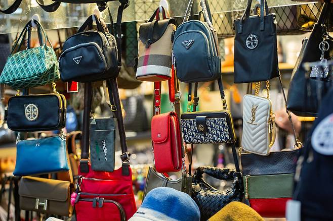 Counterfeit products displayed in stores at Seoul Express Bus Terminal's underground shopping mall. Luxury brands like Tory Burch, Prada, and Yves Saint Laurent are all found in a single shop. /Kim Yong-jae
