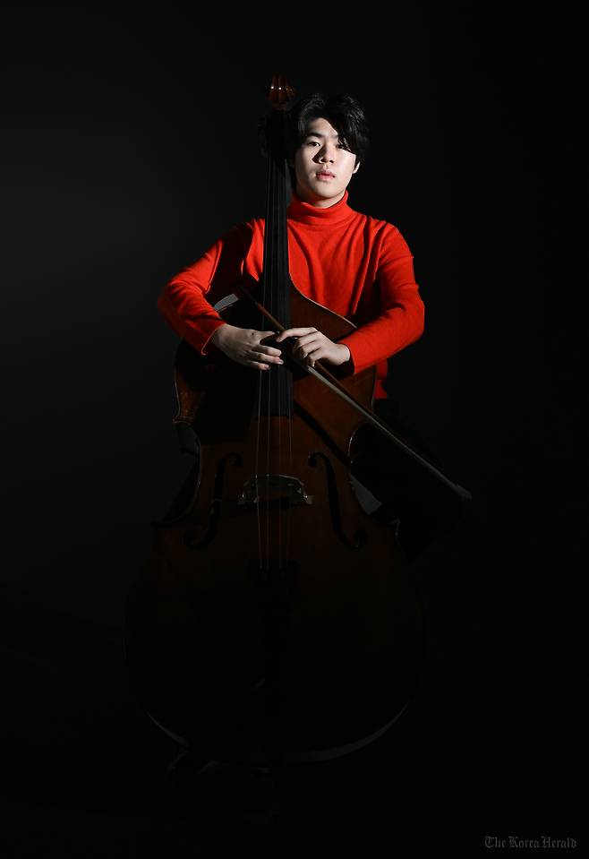 Double bassist Ryu Si-heon poses for photos during an interview with The Korea Herald on Dec. 26, 2024. (Lee Sang-sub/The Korea Herald)