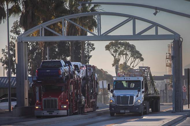1일(현지시간) 미국 캘리포니아 샌디에이고의 미국-멕시코 국경에 있는 오타이 메사 입국항에서 차량과 철강을 실은 트럭이 미국으로 진입하고 있다. [AFP]