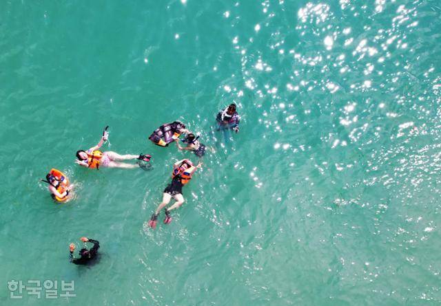 빈탄섬 여행객이 수상가옥 주변에서 스노클링을 즐기고 있다.