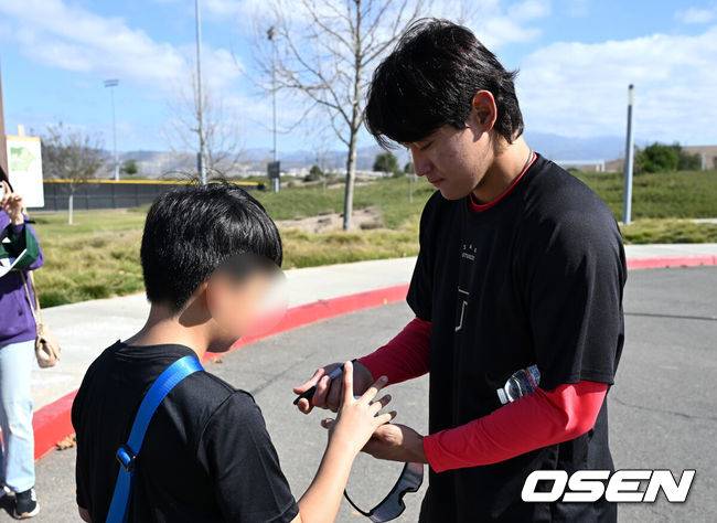 [OSEN=어바인(미국), 이대선 기자] 11일(한국시간) 미국 캘리포니아주 어바인 그레이트파크 베이스볼 컴플렉스에서 KIA 타이거즈의 1차 스프링캠프가 진행됐다.KIA 선수단은 오는 18일 미국에서 출발해 19일 인천으로 입국한 뒤 20일에 일본 오키나와로 건너가 21일부터 3월 4일까지 킨 구장에서 본격적인 실전을 치른다.KIA 김도영이 훈련장을 방문한 어린이 팬들에게 사인을 해주고 있다. 2025.02.11 / sunday@osen.co.kr
