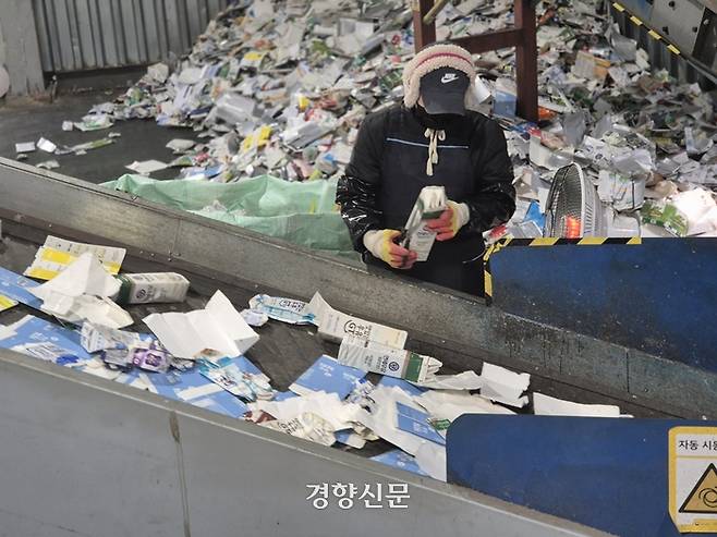 지난 20일 충북 청주시 소재 종이팩 선별 작업장에서 노동자가 일반팩과 멸균팩을 분류하고 있다. 반기웅 기자