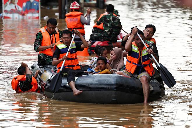4일(현지시간) 인도네시아 자카르타에서 폭우가 내린 후 구조대원들이 고무보트를 이용해 침수된 주택가에서 사람들을 대피시키고 있다. 2025.3.6 ⓒ 로이터=뉴스1 ⓒ News1 이동해 기자