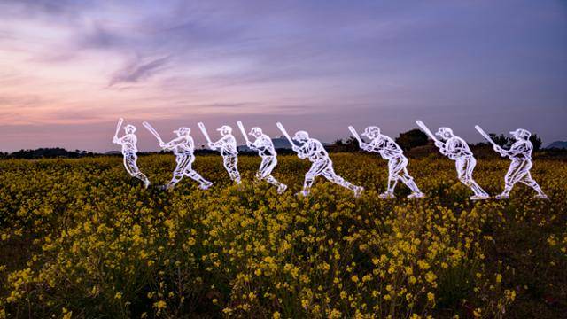 용역안에서 야구장 예정지로 지목된 부지 인근 유채꽃밭 모습. 야구 연습 중인 선수들의 모습을 이미지 생성 AI 미드저니(Midjourney)로 만들고, 실제 현장에서 '라이트 페인팅' 기법으로 재현했다. 서귀포=하상윤 기자