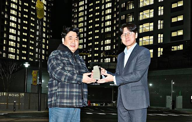 장흥역 경남아너스빌 북한산뷰 입주 기념 점등식에서 이기동 경남기업 대표이사가 김국지 입주예정자협의회장으로부터 감사패를 받고 있다. 사진=경남기업