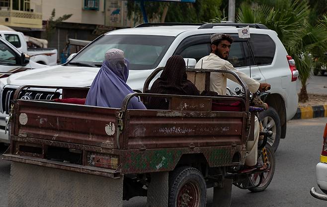 2022년 8월 아프가니스탄 칸다하르의 한 길에서 여성들이 이동하고 있다. 2021년 8월 탈레반이 아프가니스탄을 점령한 후 여성들은 직장활동이 금지되었고 12세 이상은 학교에 가거나 교육을 받을 수 없게 되었다. 게티이미지