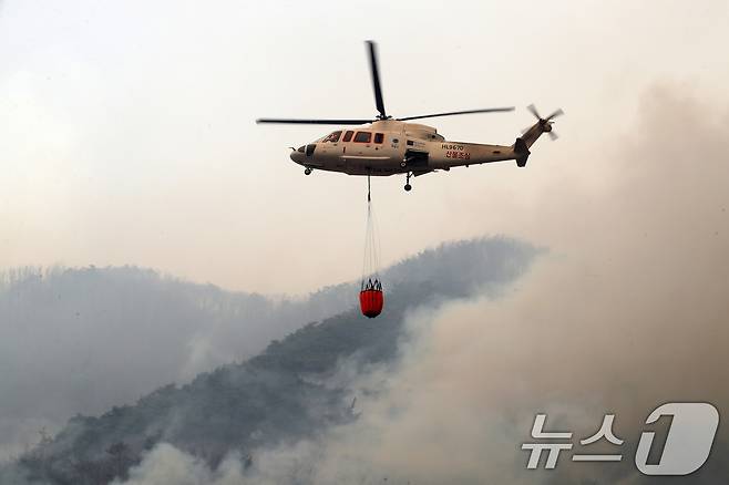 의성 산불 나흘째인 25일 오전 경북 안동시 길안면 백자리 민가 뒷산에서 산불진화에 투입된 헬기가 강풍을 뚫고 쉴 새 없이 물을 퍼 나르고 있다. 2025.3.25/뉴스1 ⓒ News1 공정식 기자