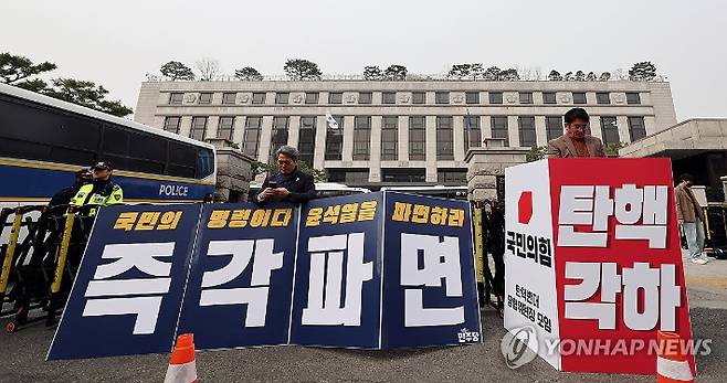 (서울=연합뉴스) 신현우 기자 = 25일 서울 종로구 헌법재판소 앞에서 더불어민주당 김기표 의원이 윤석열 대통령 파면 촉구 1인 시위를, 국민의힘 박종진 인천 서구 을 당협위원장이 윤 대통령 탄핵 반대 1인 시위를 하고 있다. 2025.3.25 nowwego@yna.co.kr 연합뉴스