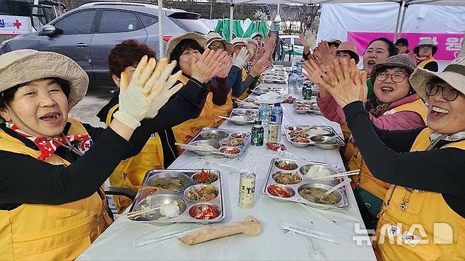 [의성=뉴시스] 김진호 기자 = 27일 경북 의성군 산불 현장통합지휘본부 일대에 굵은 비가 쏟아지자 대한적십자사 봉사자들이 박수치며 환호하고 있다. 2025.03.27. kjh9326@newsis.com
