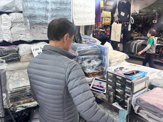 4일 오전 11시 대구 중구 서문시장에서 한 상인이 윤석열 전 대통령 탄핵 선고 생중계를 보고 있다. 대구=백경서 기자