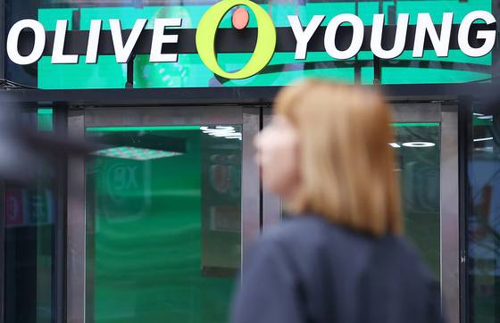A pedestrian walks by a Olive Young branch in Seoul on March 12. [YONHAP]