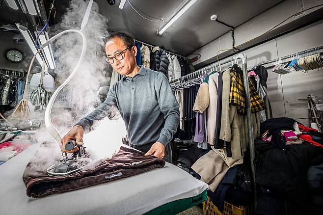 서울 응봉동에서 30년간 세탁소를 운영한 이상재 사장이 스팀다리미로 코듀로이 바지를 다리고 있다. 겨울이 끝나고 봄이 시작되는 4월은 세탁업계의 성수기. 10평 남짓한 공간에 패딩 잠바와 스웨터 등이 가득 쌓여 있었다. /이신영 영상미디어 기자