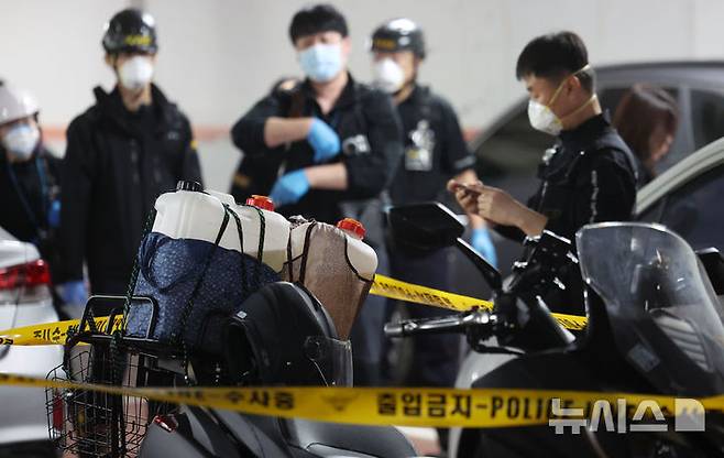 [서울=뉴시스] 홍효식 기자 = 21일 오전 서울 관악구 봉천동 화재가 발생한 아파트 지하주차장에서 과학수사대가 기름통이 실린 오토바이를 조사하고 있다. 2025.04.21. yesphoto@newsis.com