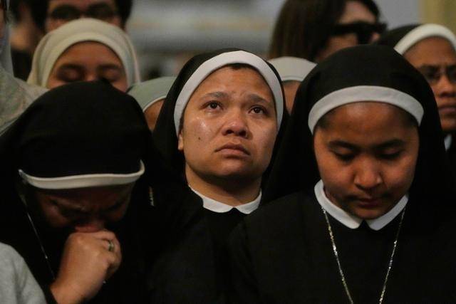 21일 로마의 성 요한 라테란 대성당에서 열린 고 프란치스코 교황 미사에서 수녀들이 교황의 사진을 보며 눈물을 흘리고 있다. 로마=AP 뉴시스