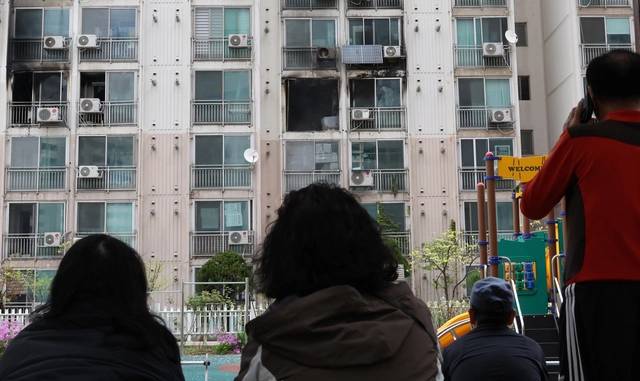 지난 21일 서울 관악구 봉천동 한 아파트에서 화재가 발생, 주민들이 현장을 바라보고 있다. 연합뉴스