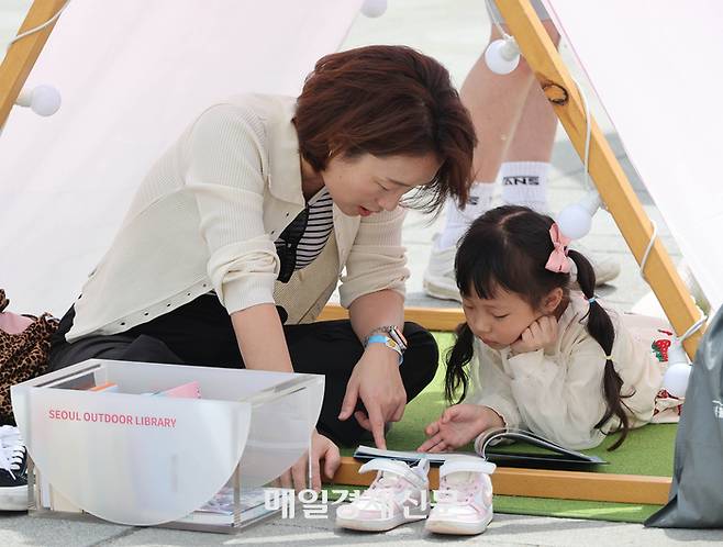 봄을 맞아 광화문, 청계천 등지에서 서울 야외 도서관이 개장한 가운데 광화문 광장을 찾은 시민들과 관광객들이 책을 보며 휴식을 취하고 있다.

올해로 4년 차를 맞이하는 서울 야외 도서관은, 광화문광장 ‘광화문 책 마당’, 청계천 ‘책 읽는 맑은 냇가’는 23일 개장하고, 서울광장 ‘책 읽는 서울광장’은 어린이날을 맞아 5월 3일 문을 연다. 서울 야외 도서관 세 곳 모두 금, 토, 일 주 3일제로 운영한다. 4~6월, 9~11월 초로 나눠 운영된다. 2025.04.23[이충우 기자]