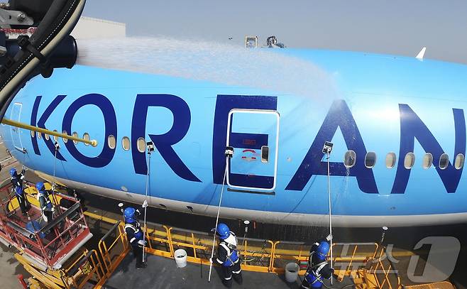 24일 오전 인천 중구 인천국제공항 대한항공 격납고에서 직원들이 봄을 맞아 항공기 동체를 세척하고 있다. 이날 세척한 항공기는 보잉 777-300ER 기종으로 대한항공의 새 도장이 적용된 기체다. (공동취재) ⓒ News1 장수영 기자