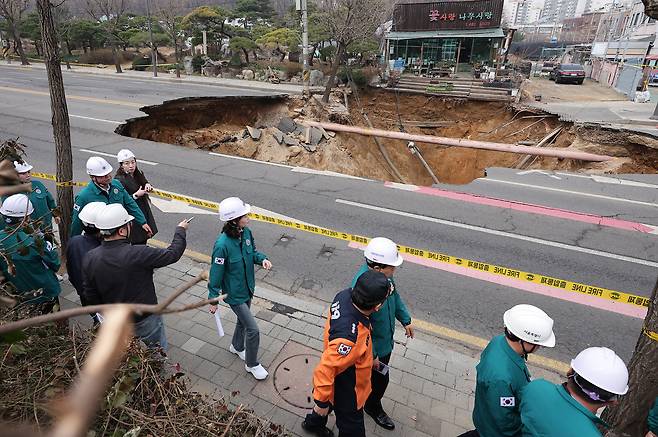 25일 서울 강동구 대명초등학교 인근 사거리에서 싱크홀(땅 꺼짐) 사고 발생으로 교통이 통제되고 있다./뉴스1