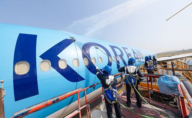 ‘KOREAN’이라는 이름 위로 흐르는 물결, 신뢰를 닦는 손길이 분주하다. 정비는 기술을 넘어, 브랜드의 철학을 되새기는 움직임이다. (대한항공 제공)