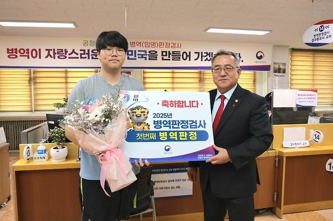 김종철 병무청장(오른쪽)이 지난 1월 13일 서울 영등포구 서울지방병무청에서 올해 처음으로 병역판정을 받은 청년을 격려하고 있다. 병무청 제공