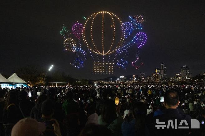 [서울=뉴시스] 김명년 기자 = 27일 오후 서울 광진구 뚝섬한강공원 수변무대에서 2025 한강 불빛 공연(드론 라이트 쇼)이 펼쳐지고 있다. 2025.04.27. kmn@newsis.com