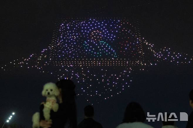 [서울=뉴시스] 김명년 기자 = 27일 오후 서울 광진구 뚝섬한강공원 수변무대에서 2025 한강 불빛 공연(드론 라이트 쇼)이 펼쳐지고 있다. 2025.04.27. kmn@newsis.com