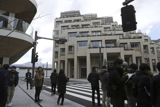 Reporters see the apartment complexes and the roads where a mobility will be tested at Toyota’s Woven City during a tour in Susono, Shizuoka prefecture, Saturday, Feb. 22. [AP/YONHAP]