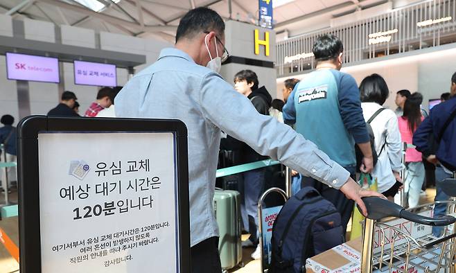 30일 인천국제공항 제1여객터미널 SK텔레콤 로밍센터에서 출국을 앞둔 SK텔레콤 이용자들이 유심 교체를 위해 줄을 서서 기다리고 있다.&nbsp;인천공항=이제원 선임기자