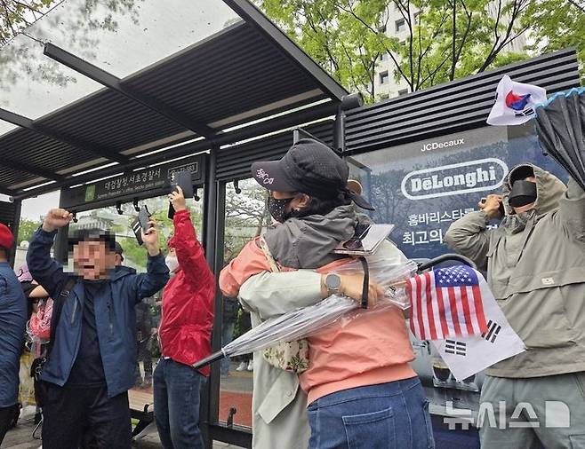 [서울=뉴시스]조기용 수습기자=1일 오후 이재명 더불어민주당 대선 후보의 공직선거법 위반 혐의에 대한 대법원 판결이 '파기환송'으로 내려지자 대검찰청 정문 앞에서 집회를 벌이던 보수단체 참가자들이 환호하는 모습. 2025.05.01