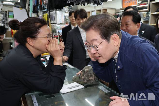 [화천=뉴시스] 조성우 기자 = 민심을 청취하는 '경청 투어'에 나선 이재명 더불어민주당 대선후보가 2일 오후 강원도 화천군 화천공영버스터미널 인근의 한 군장점에서 상인의 말에 귀를 기울이고 있다. (공동취재) 2025.05.02. photo@newsis.com
