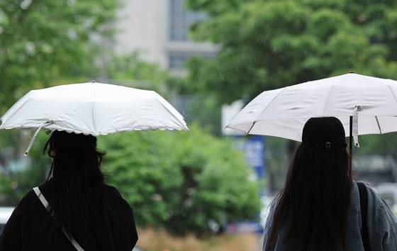 People walk with umbrellas near Coex in Gangnam District, southern Seoul, on May 1. [NEWS1]