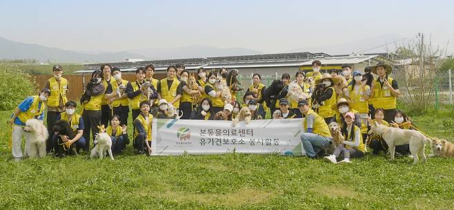 본동물의료센터 임직원과 내추럴발란스 블루엔젤봉사단이 안성 평강공주 보호소에서 봉사활동 진행 후 기념 사진을 찍고 있다(동물병원 제공). ⓒ 뉴스1