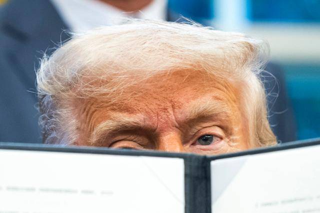 도널드 트럼프 미국 대통령이 5일 미국 워싱턴 백악관 집무실에서 행정명령에 서명한 뒤 이를 보여주고 있다. 워싱턴=EPA 연합뉴스