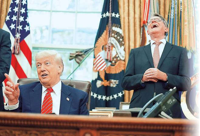 도널드 트럼프(왼쪽) 미국 대통령이 8일(현지시간) 미 워싱턴 D.C. 백악관의 오벌 오피스에서 미국과 영국 간의 무역 협정을 발표한 뒤 언론과 재치있는 문답을 주고받자 피터 맨델슨 주미 영국대사가 크게 웃으며 호응했다.  [AP]