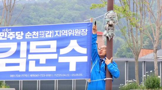 자신의 홍보 현수막을 철거하는 김문수 민주당 의원. (사진=김문수 민주당 의원 페이스북)