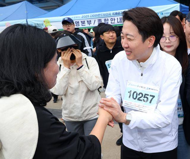 이준석(오른쪽 두 번째) 개혁신당 대선 후보가 11일 부산 해운대구 벡스코 일대에서 열린 다이아몬드브릿지 걷기축제에 참가해 시민들에게 인사하고 있다. 연합뉴스