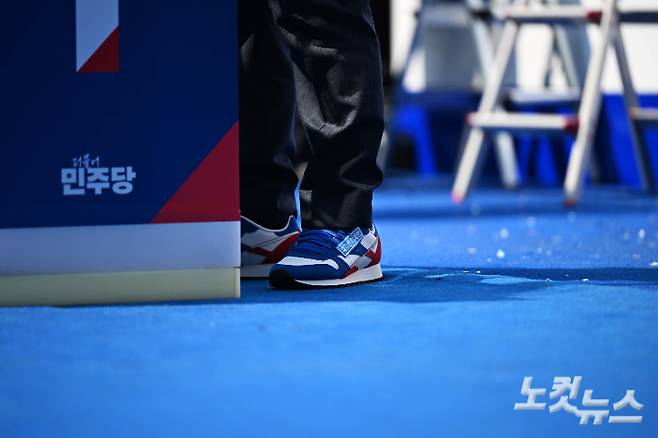 지난 12일 이재명 더불어민주당 대통령 후보가 제21대 대통령선거 공식 선거운동이 시작된 서울 종로구 청계광장에서 열린 중앙선거대책위원회 출정식에서 구두를 벗고 운동화를 신고 있다. 류영주 기자