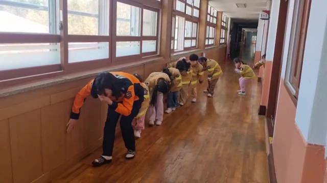 ▲전북소방본부 소방관들과 초등학생들이 화재 상황을 가정한 대피훈련을 하고 있다. ⓒ전북특별자치도소방본부 제공