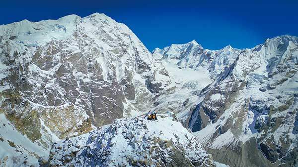 얄라피크 정상에 선 팀원들. 뒤편 왼쪽에 솟은 샬바춤Shalbachum(6,707m)을 기준으로 네팔과 중국 국경으로 나뉜다. 사진상으로는 보이지 않지만, 왼편으로 랑탕리룽과 오른편으로 시샤팡마가 있다.