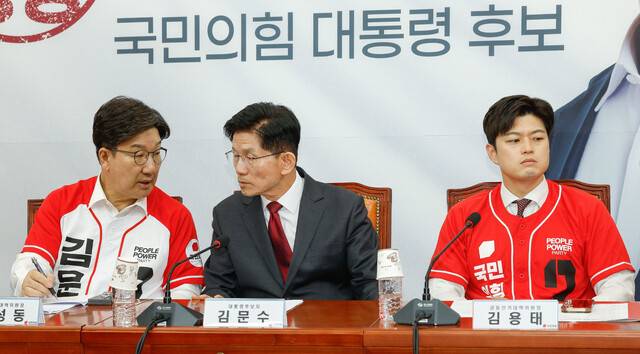 김문수 국민의힘 대통령 후보(가운데)와 권성동 공동선거대책위원장(왼쪽)이 15일 서울 여의도 국회에서 열린 중앙선대위 회의 및 임명장 수여식에서 대화를 나누고 있다. 오른쪽은 김용태 비상대책위원장. 공동취재사진