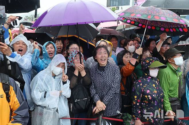 [여수=뉴시스] 권창회 기자 = 이재명 더불어민주당 대선 후보가 15일 전남 여수시 이순신광장에서 열린 집중유세에서 연설을 하는 가운데 시민들이 우산을 쓰고 이 후보 연설을 듣고 있다. (공동취재) 2025.05.15. photo@newsis.com
