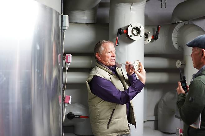 마을의회 의원(게마인데라트)인 토마스 플루거가 행정청사 지하에 있는 대형 보일러에 대해 설명하고 있다. 이 보일러는 마을의 공공기관과 주택에 80~90도의 뜨거운 물을 공급한다. 일종의 ‘중앙 난방’이다. 이 보일러는 목공소에서 나온 목재 부스러기를 압축해 만든 ‘펠릿’을 태워 물을 데운다. 진정은씨 제공.