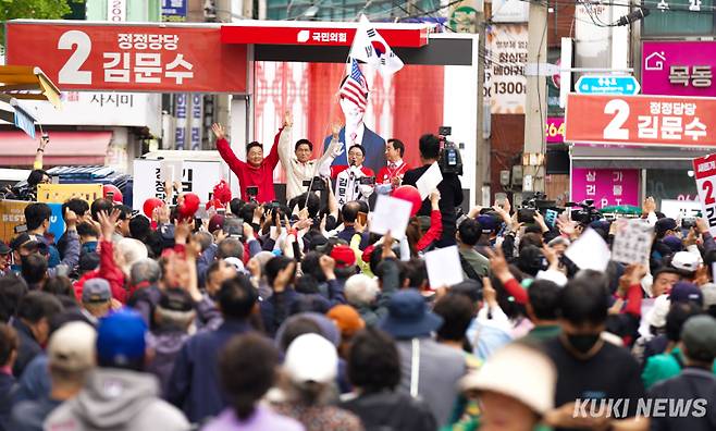 김문수 국민의힘 대선 후보가 20일 서울 강서구 남부골목시장 유세 현장에서 당직자 및 지역 관계자들과 손을 들어 보이고 있다. 유희태 기자