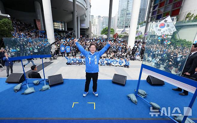 [서울=뉴시스] 권창회 기자 = 이재명 더불어민주당 대선 후보가 19일 서울 용산구 용산역 광장에서 열린 집중유세에서 방탄유리가 설치된 유세차 위에서 연설을 마치고 기념촬영을 하고 있다. 이 후보는 이날 대선 후보 최초로 방탄 유리막 안에서 유세를 시작했다. (공동취재) 2025.05.19. photo@newsis.com