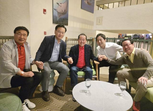▲홍준표 전 대구시장의 선대위 합류를 설득하기 위해 지난 19일 미국 하와이를 방문한 국민의힘 대선 선대위 유상범 단일화추진본부장, 김대식 대외협력본부장, 조광한 대외협력부본부장, 이성배 선대위 대변인이 홍 전 시장(가운데)과 손잡고 기념 촬영을 하고 있다. ⓒ연합뉴스