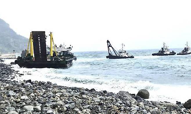 지난 24일 오후 2시30분쯤 울릉공항 공사 현장 앞바다에 정박 중인 바지선이 울릉읍 사동(일명 물래치기) 2동 해안변으로 떠밀려있다. 독자제공