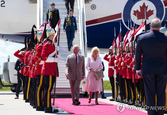 캐나다 도착한 찰스 3세 국왕 부부 (오타와 AFP=연합뉴스) 26일(현지시간) 찰스 3세 영국 국왕과 커밀라 왕비 부부가 캐나다 오타와 맥도널드-카르티에 국제 공항에 도착해 의장대 사이를 걸어가고 있다. 2025.05.27