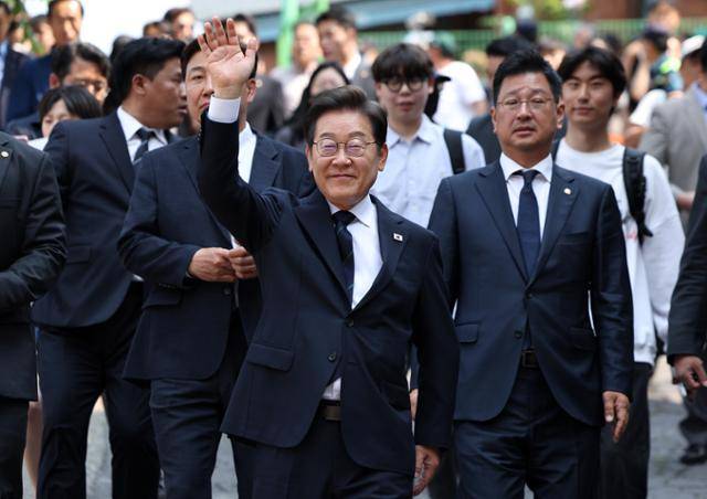 이재명 더불어민주당 대선 후보가 제21대 대통령선거 사전투표 첫날인 29일 서울 서대문구 신촌동 주민센터 투표소에 사전투표를 마치고 이동하며 시민들에게 손을 들어 인사하고 있다. 뉴시스