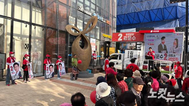 24일 서울 강북구 미아사거리역 인근에서 국민의힘 선거사무원들이 유세차량 앞에 손팻말을 들고 서 있다. 김수정 기자